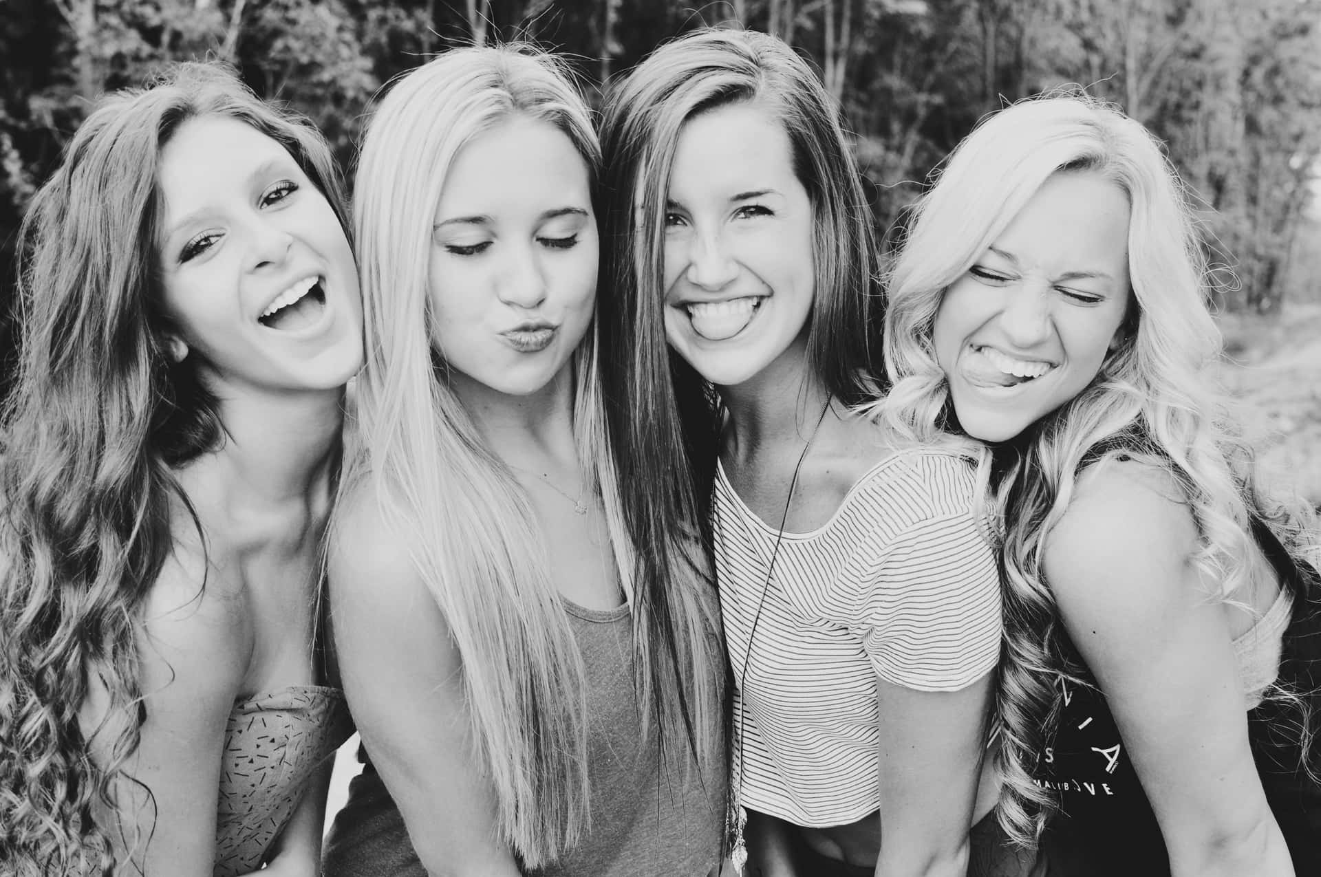 Four Girls Are Smiling And Laughing In Black And White