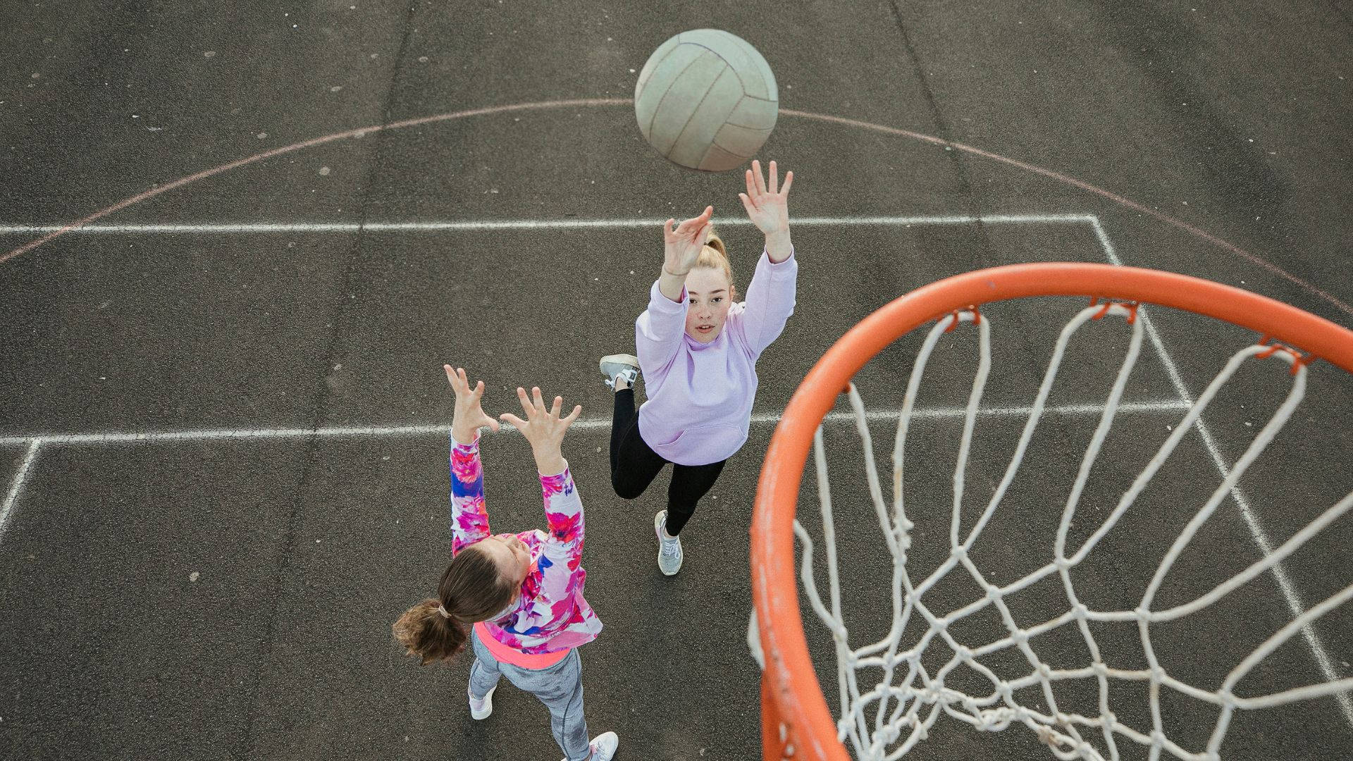 Girls Playing Netball Sports Court Wallpaper