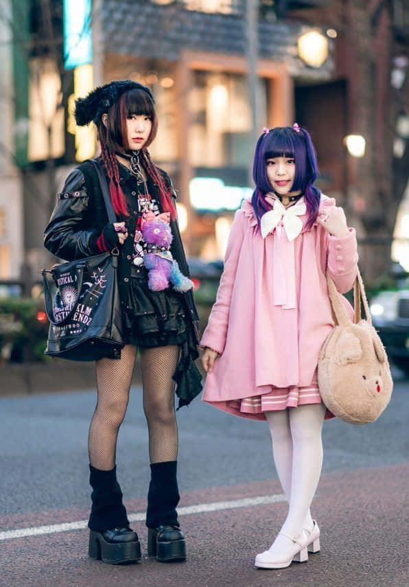 Two Girls In Pink Outfits Standing On The Street