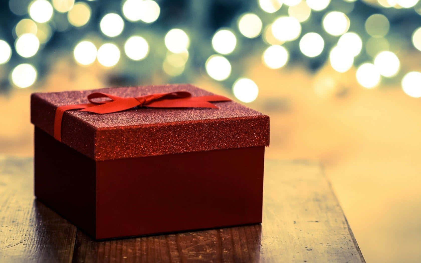 A Red Gift Box With A Bow On Top