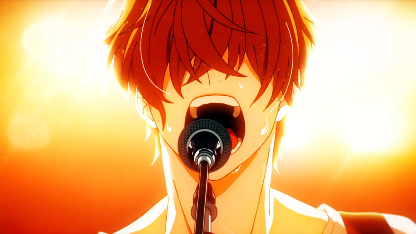 A Boy With Red Hair Singing Into A Microphone
