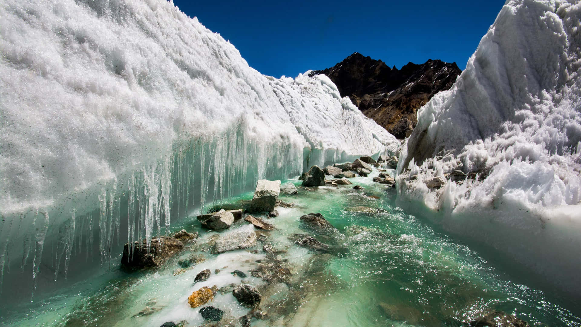 Glacial_ Stream_ Amidst_ Ice_ Formations.jpg Wallpaper