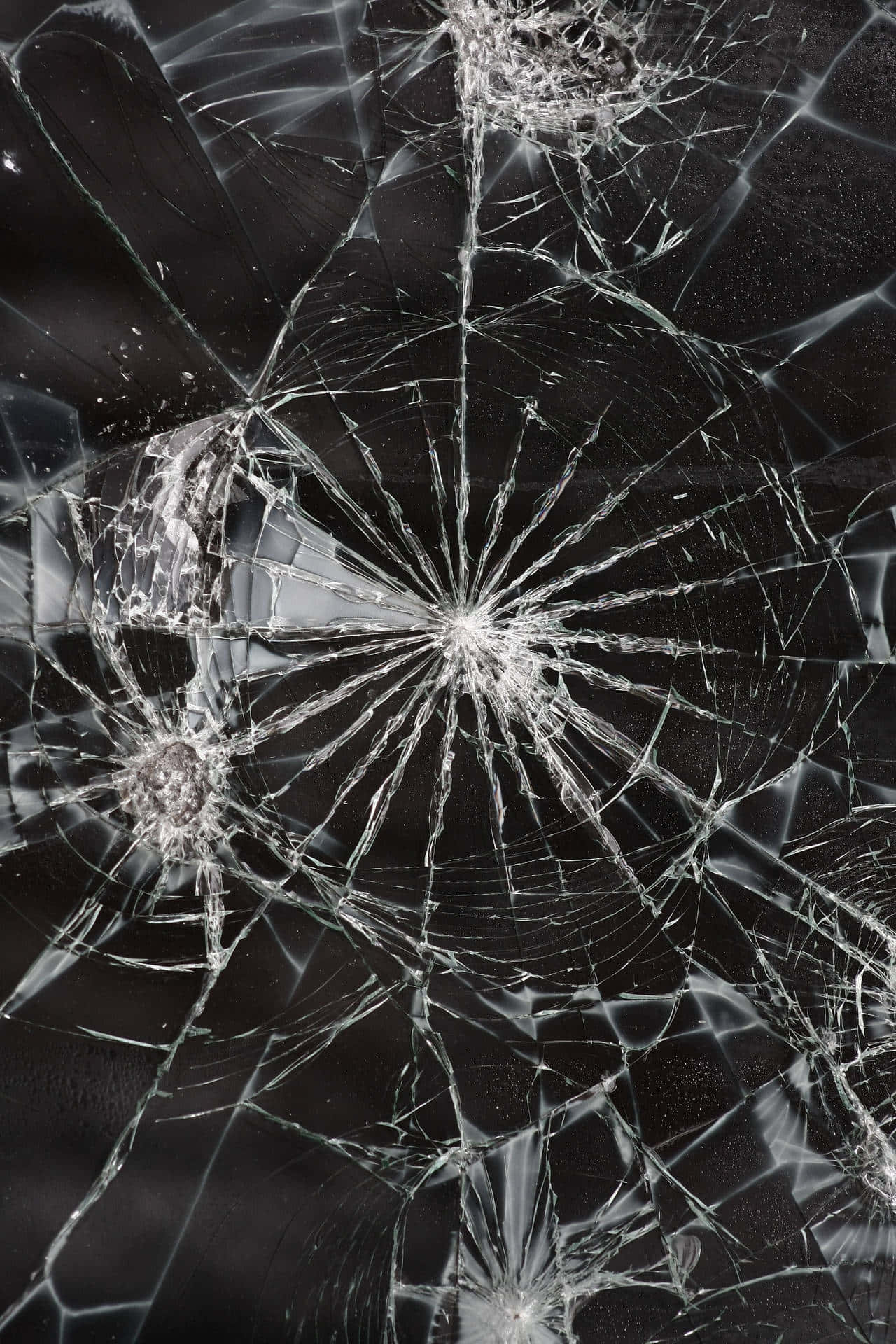 A Broken Windshield With A Lot Of Shattered Glass