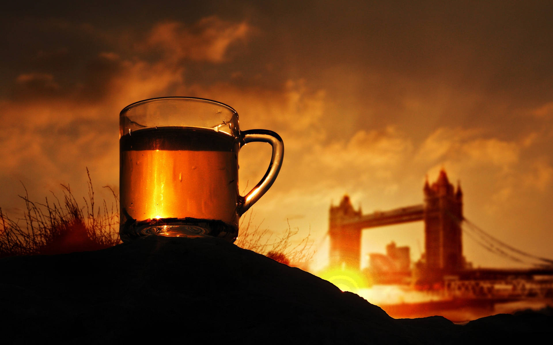 Glass Of Tea Against Sunset Skyline Wallpaper