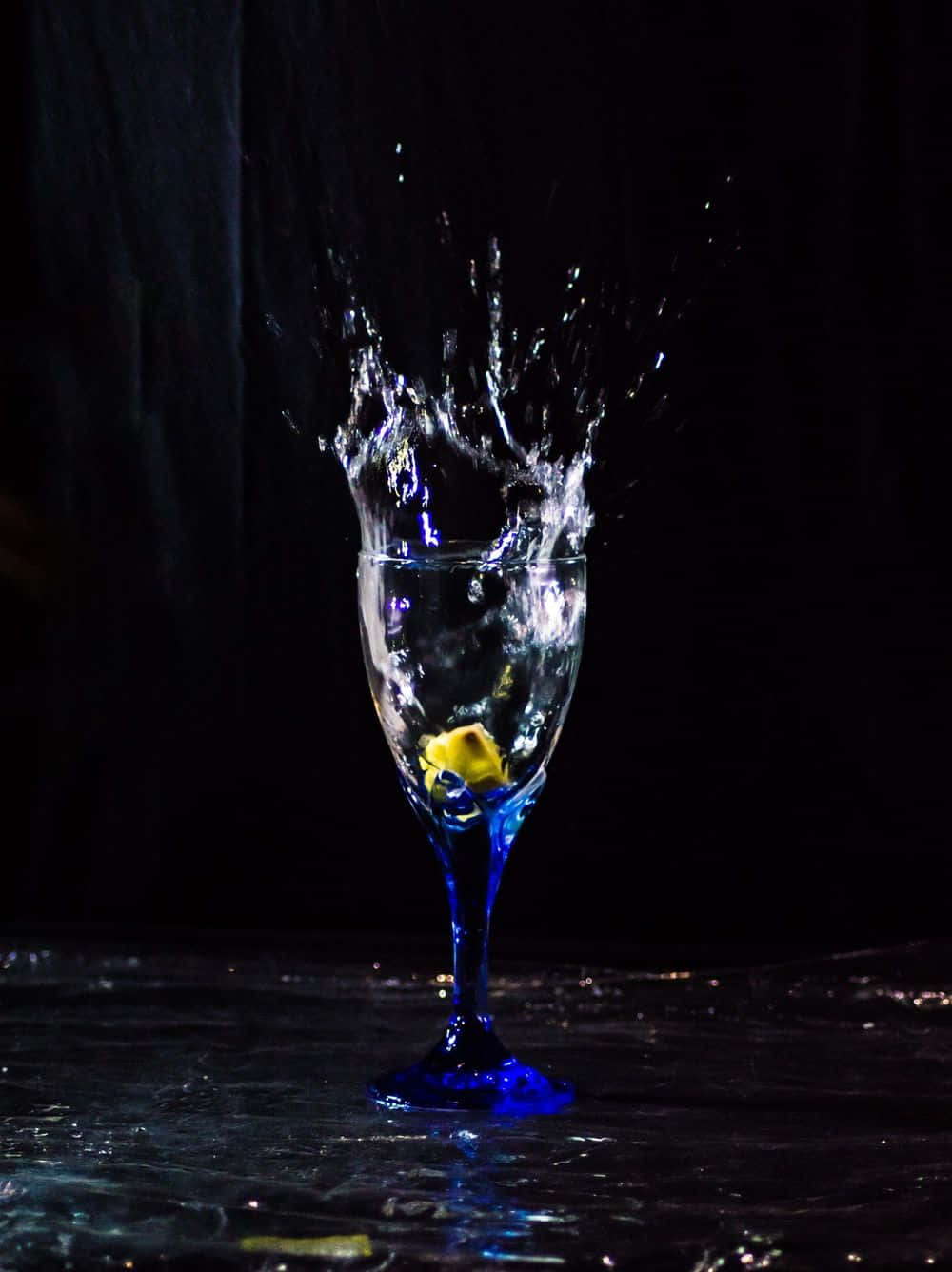 A Glass Of Water Splashing On A Black Background