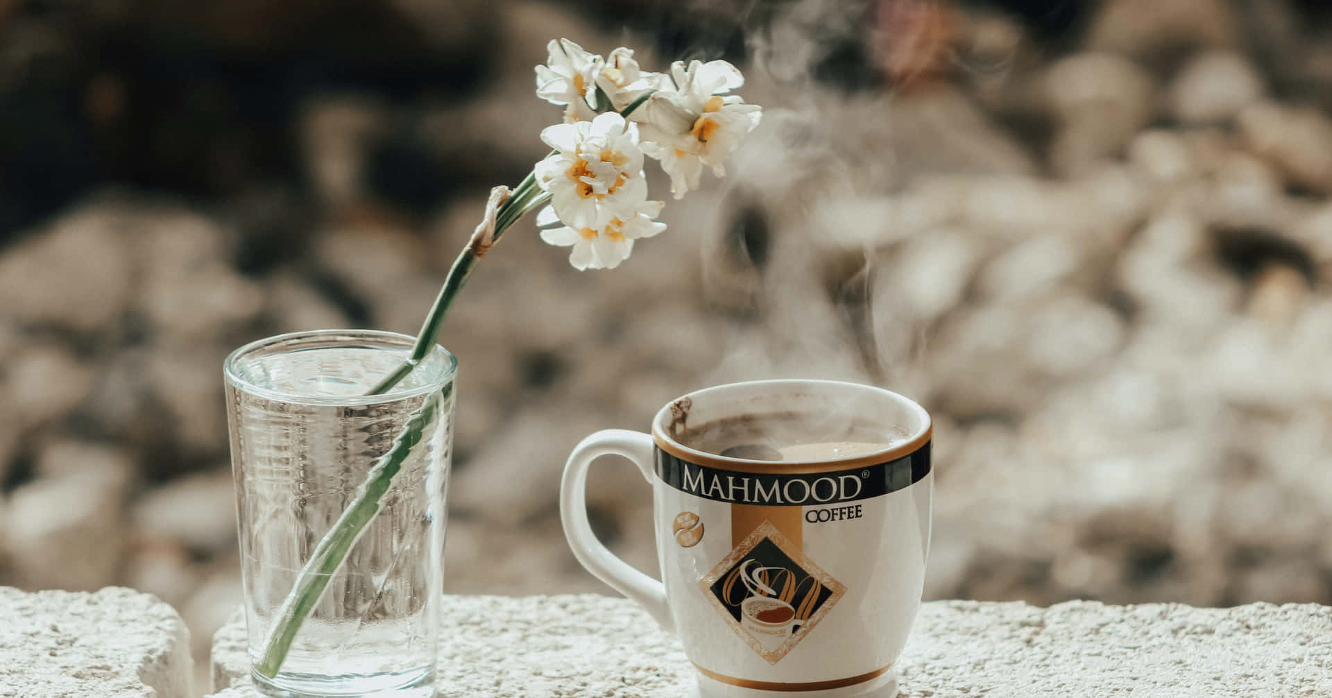 A Cup Of Coffee With Flowers On It
