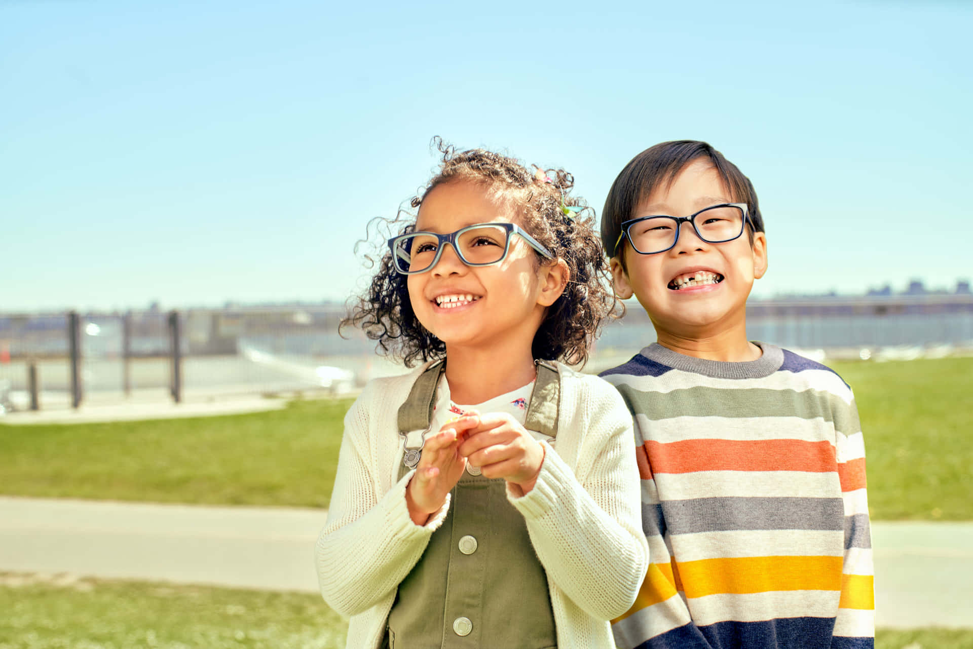 Two Children Wearing Glasses In A Park
