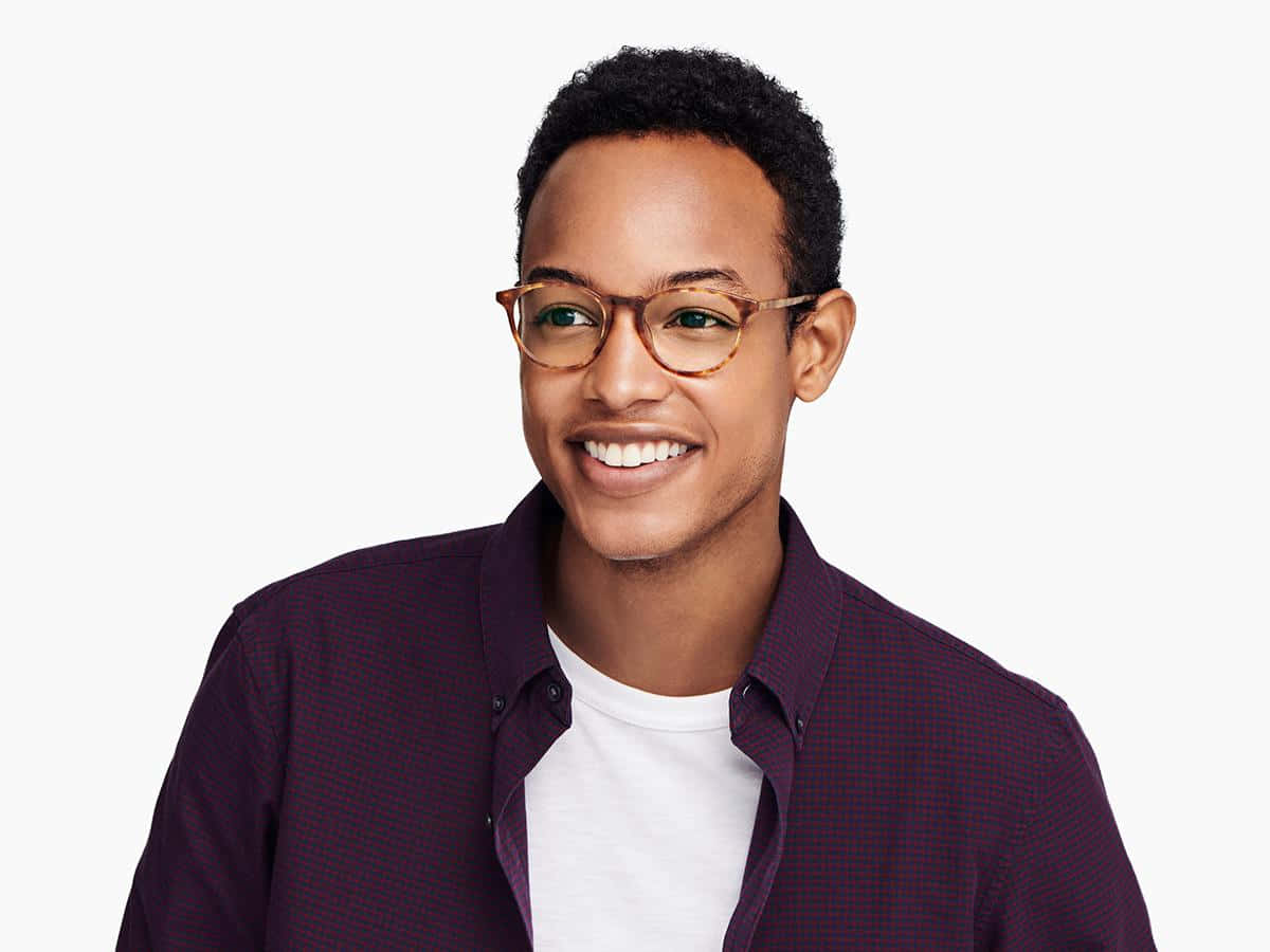 Download A Man Wearing Glasses And Smiling | Wallpapers.com