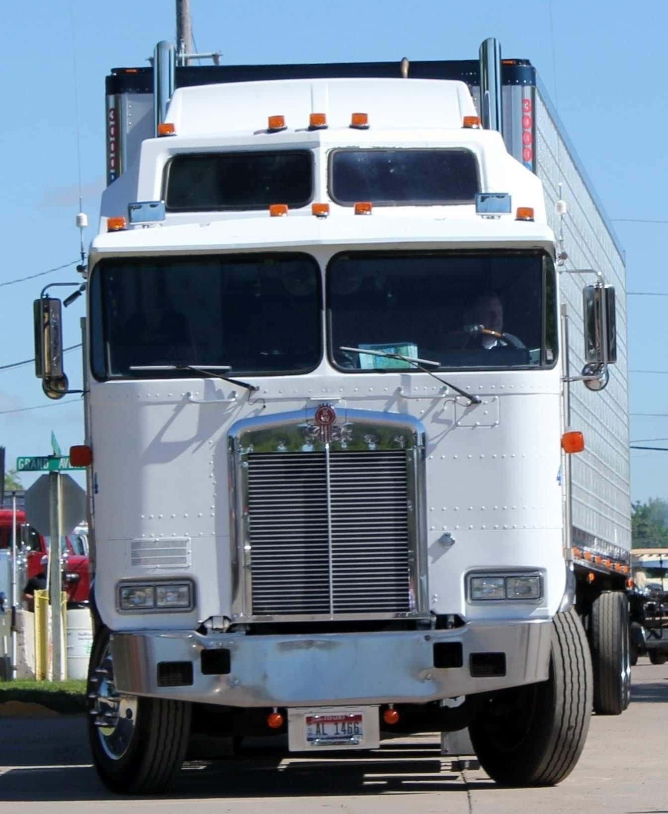 Gleaming Kenworth K100 Truck On Open Highway Wallpaper