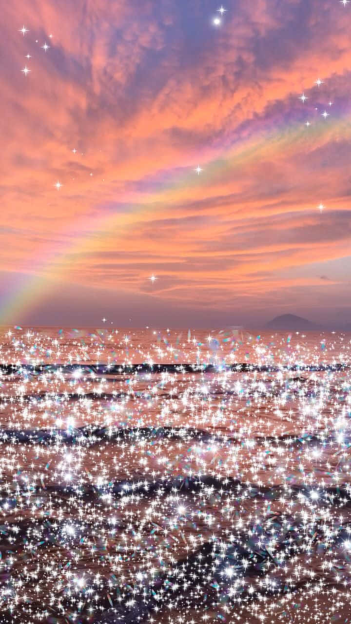 A Rainbow Over The Ocean With Stars Wallpaper