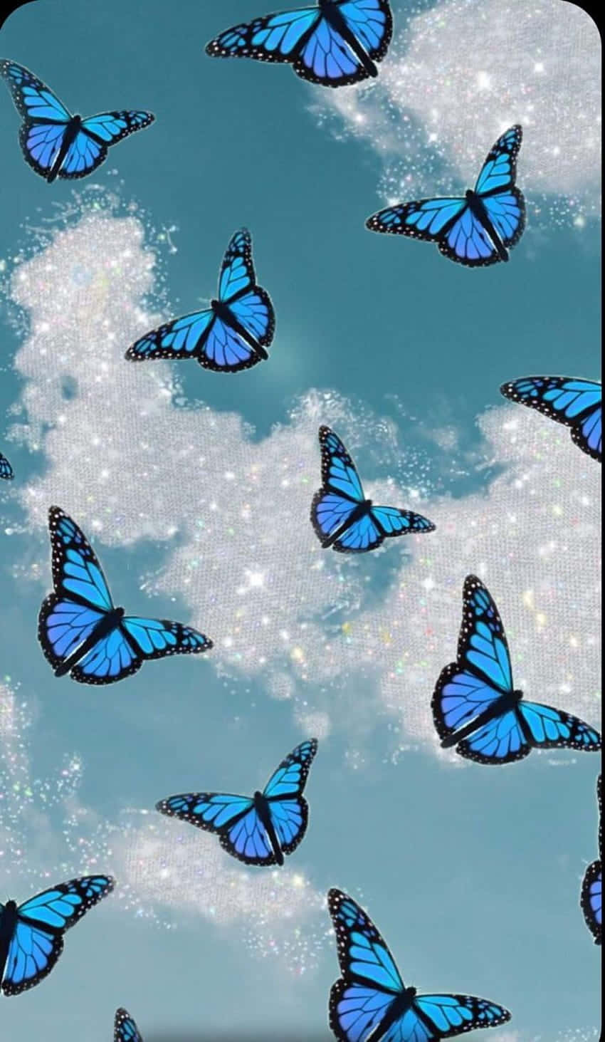 A beautiful glittering butterfly flutters through the air. Wallpaper