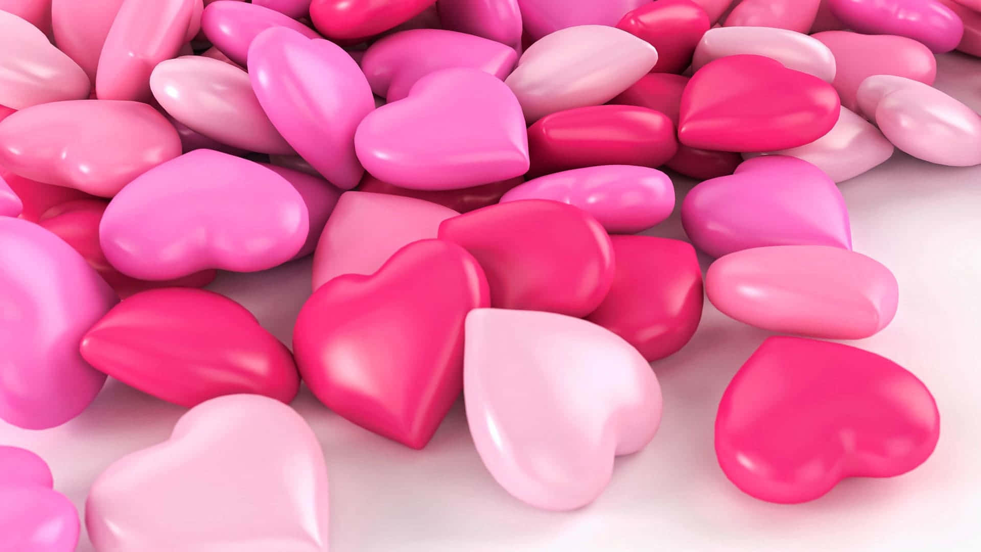 A Pile Of Pink And Pink Hearts On A White Surface Wallpaper