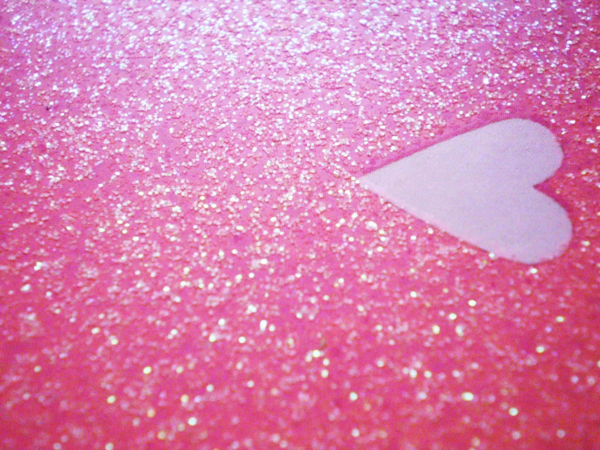 A Glittery Pink Heart Awakens Joy and Sparkles with Delight Wallpaper