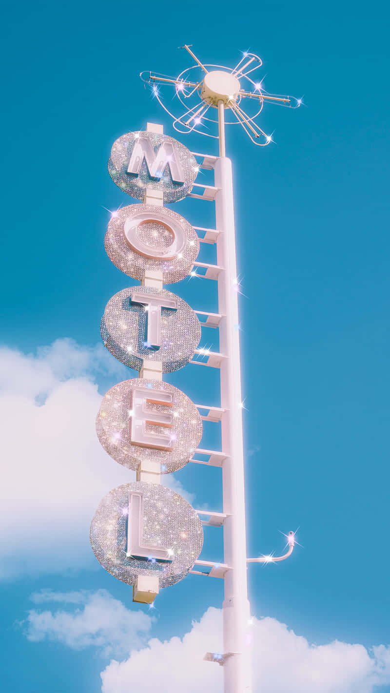 Glittering Motel Sign Against Blue Sky Wallpaper