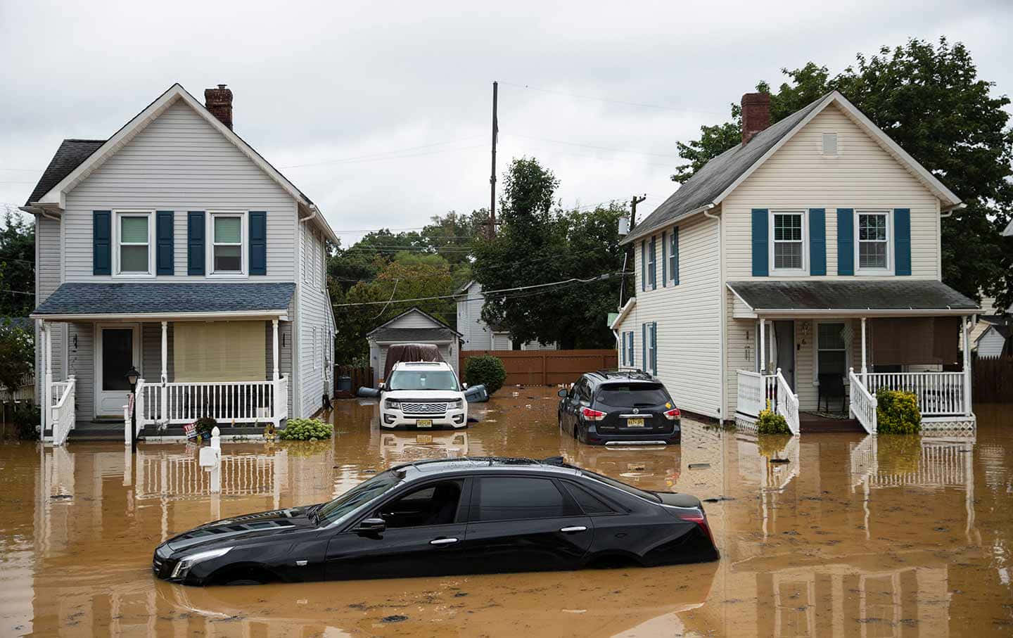 A Car Is Parked In A Flooded Street
