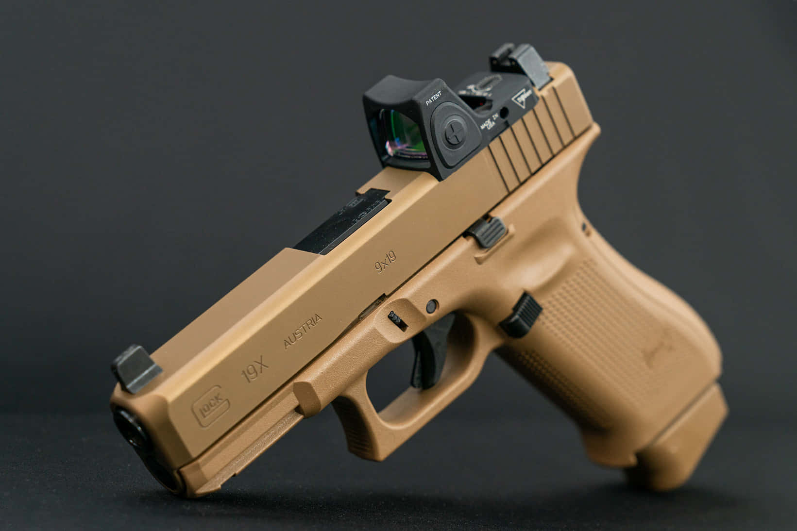 A Tan Pistol With A Red Laser Sight