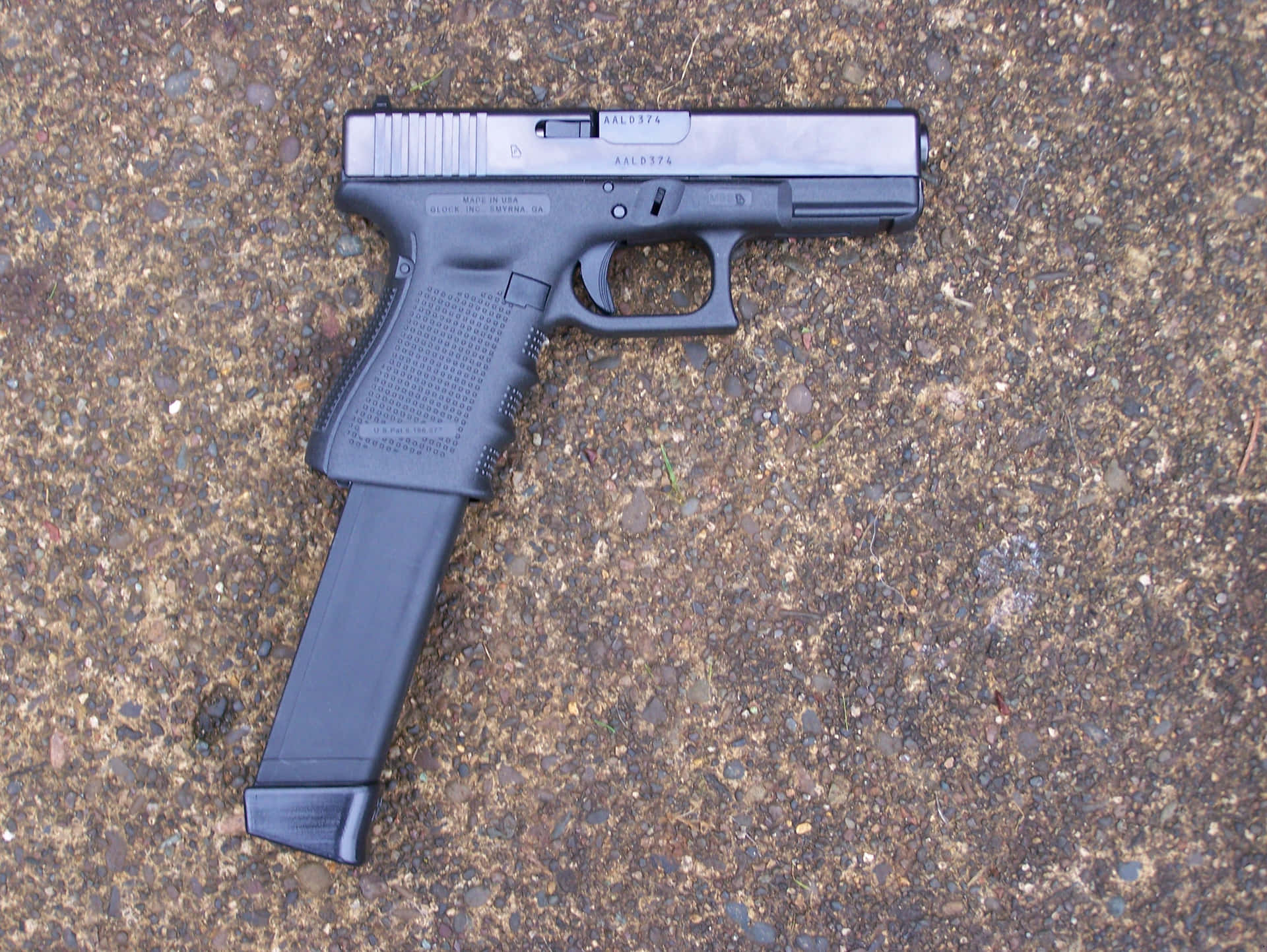 A Glock Pistol Is Laying On The Ground