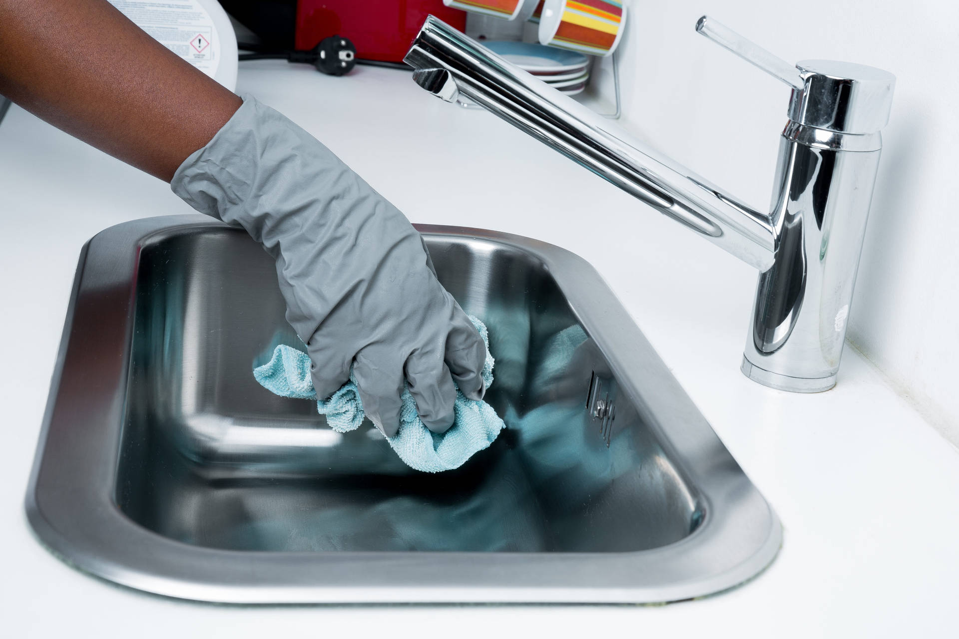 Gloved Hand Cleaning Sink House Cleaning Wallpaper