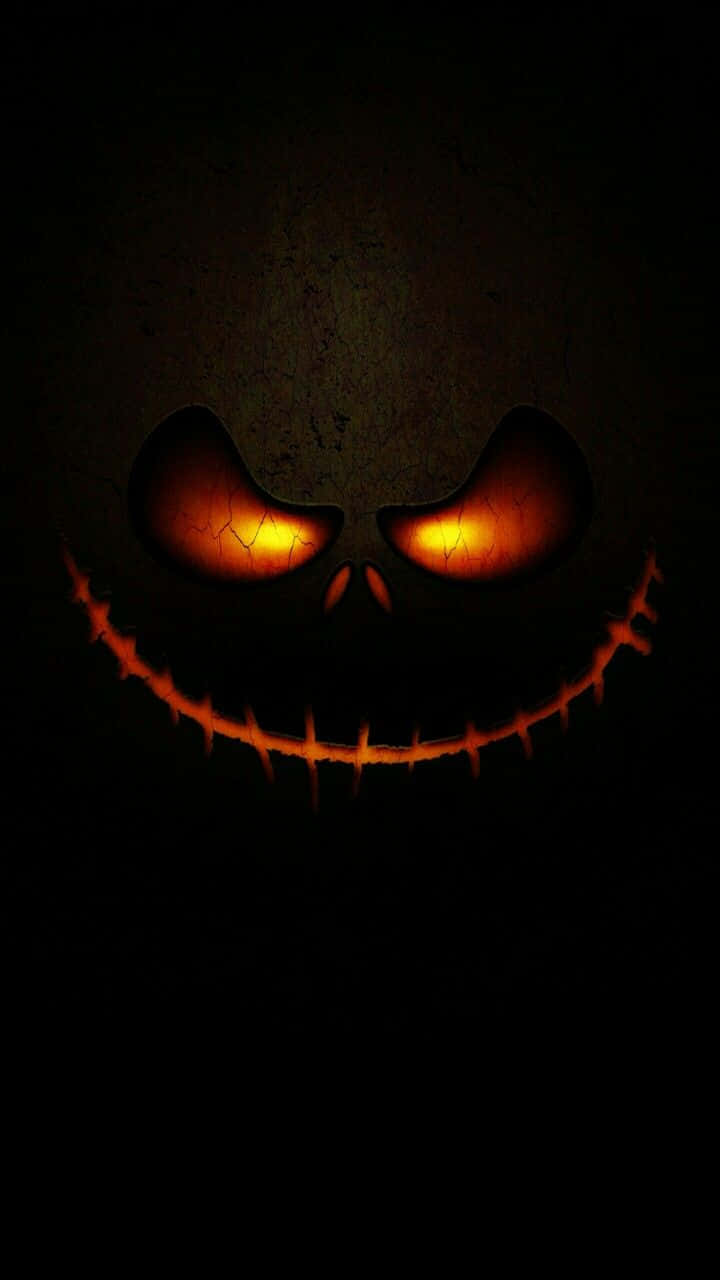 Glowing Jack O Lantern Face Dark Background.jpg Wallpaper