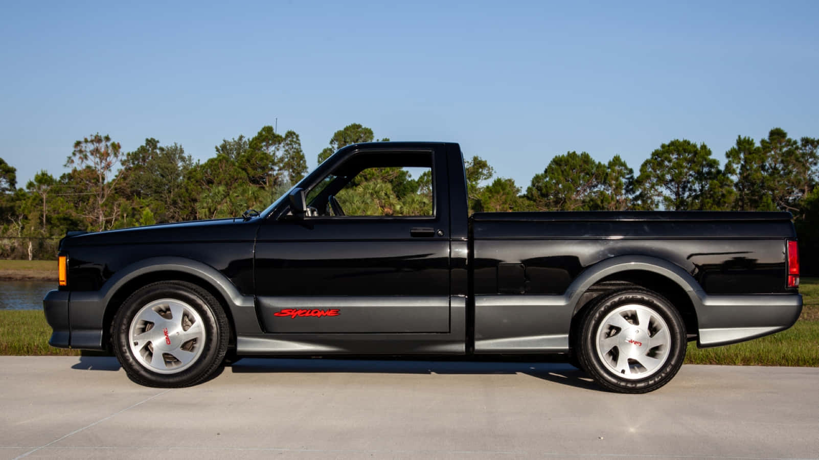 A powerful GMC Syclone showcased on the road Wallpaper