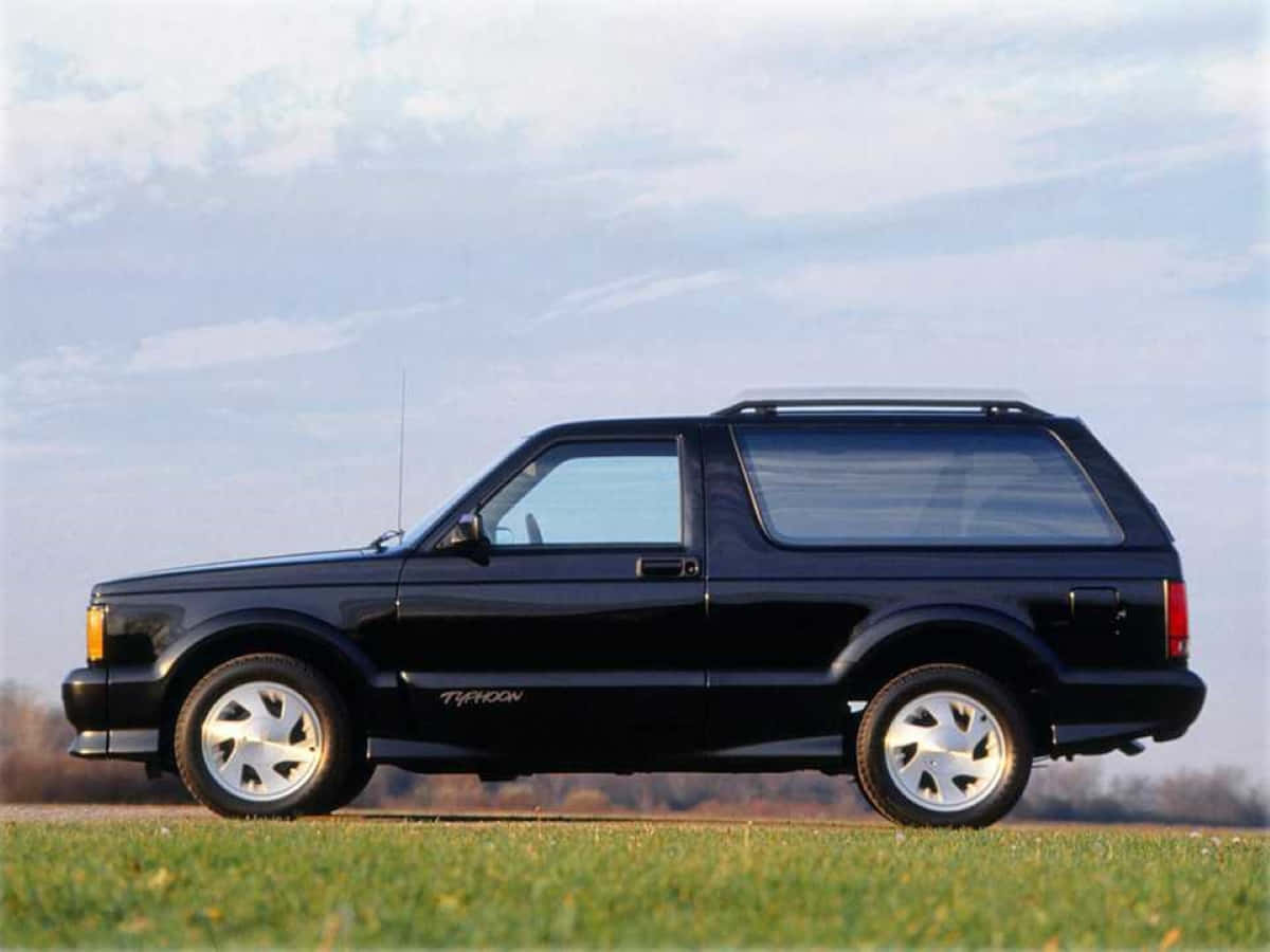 Caption: Stunning Red GMC Typhoon in its Element Wallpaper