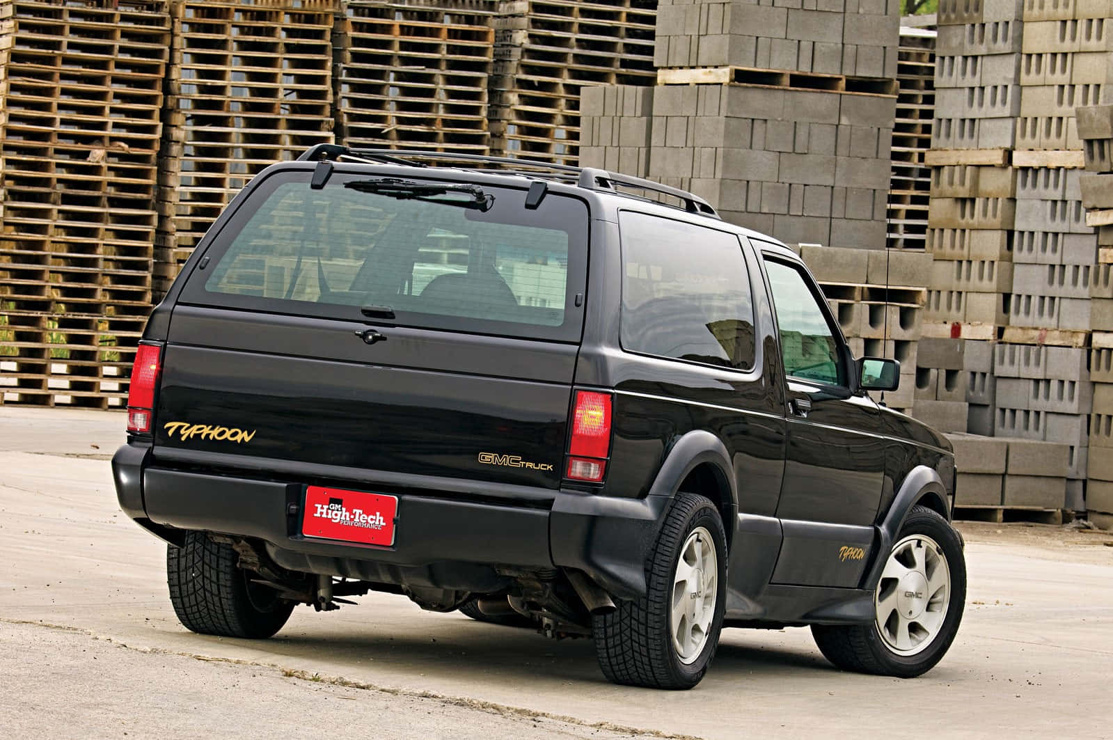 A powerful GMC Typhoon cruising on the road. Wallpaper