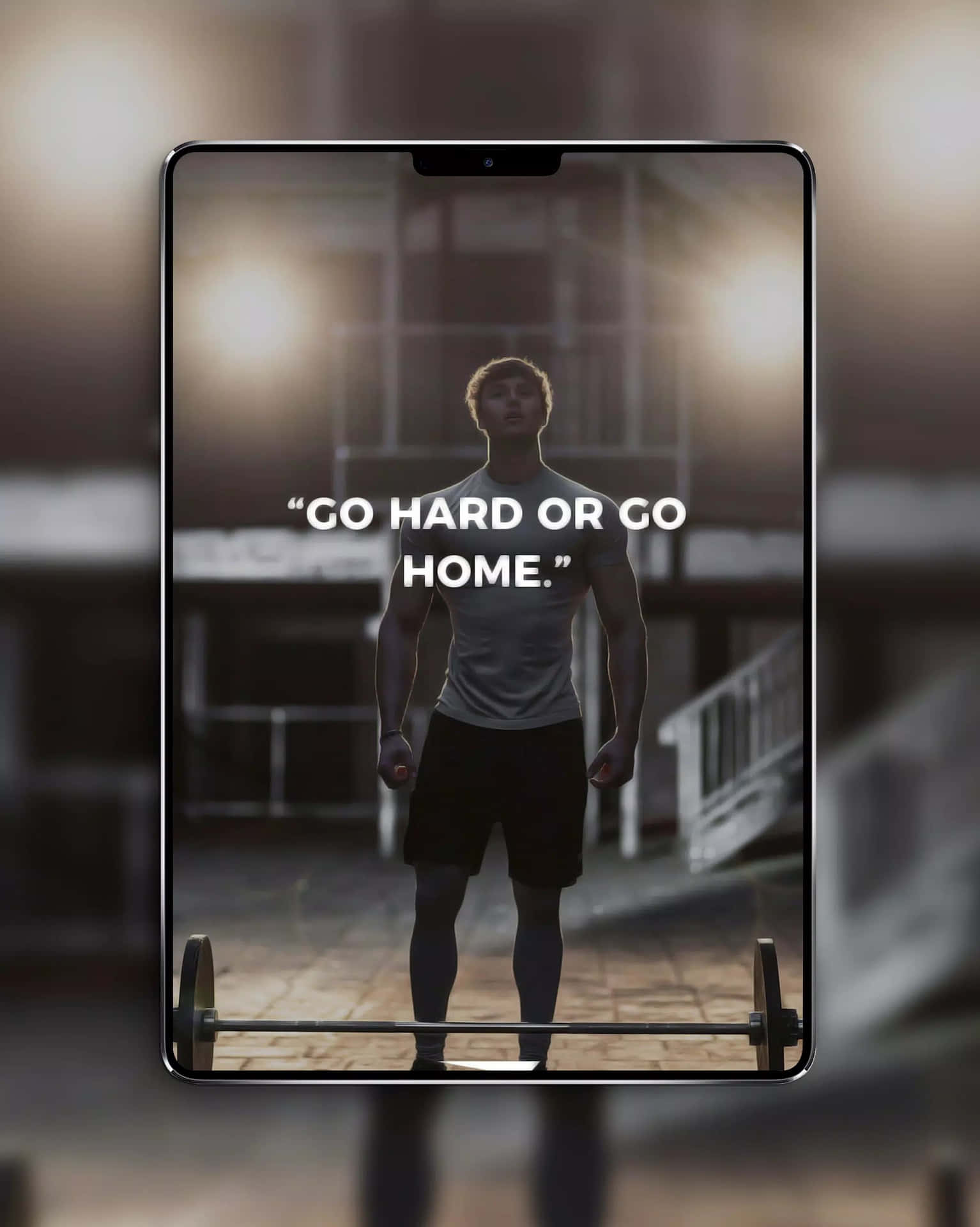 A Man Is Standing In Front Of A Tablet With The Words Go Hard Or Go Home Wallpaper