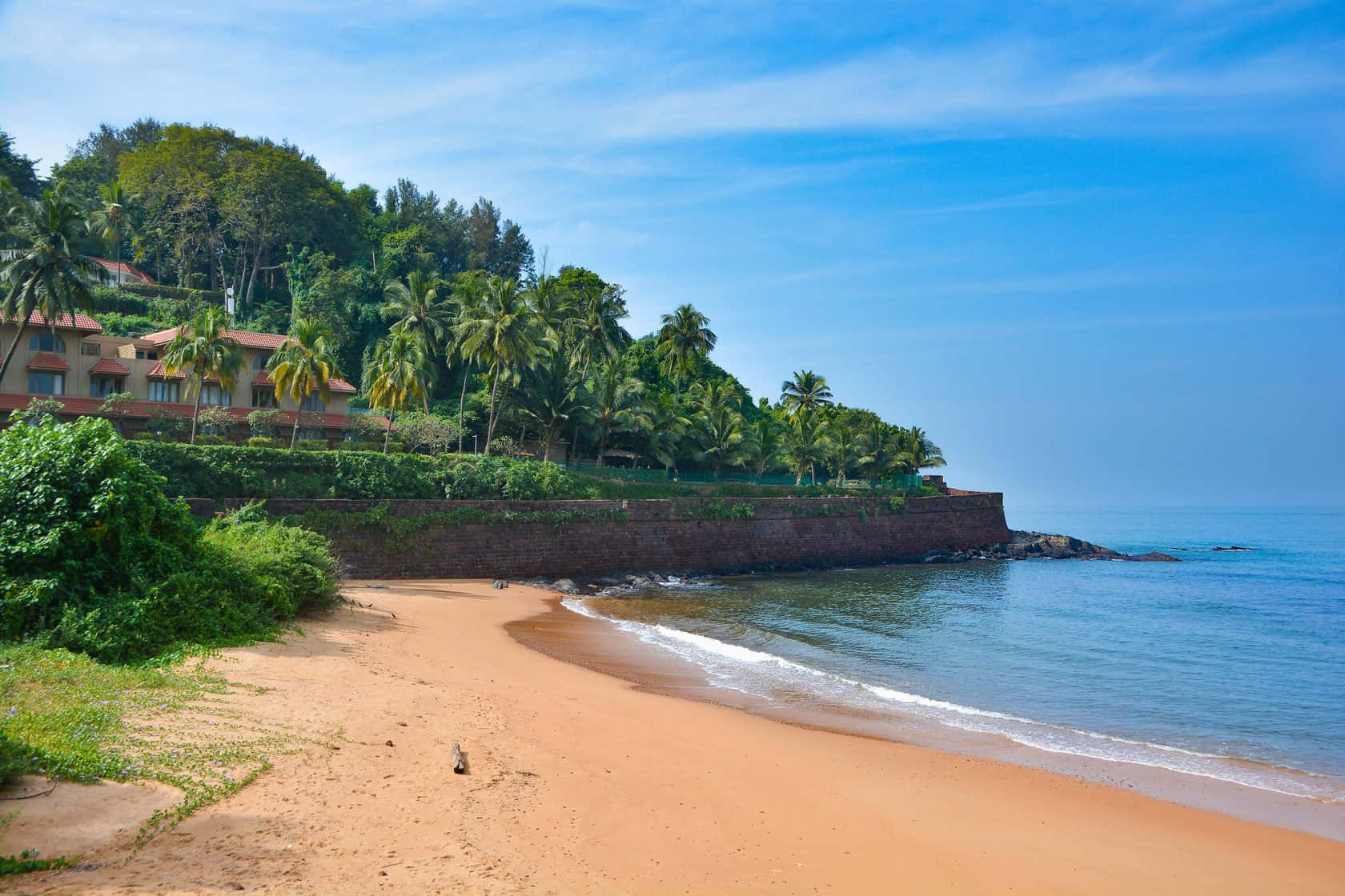 A Beach With A Resort And Trees On It