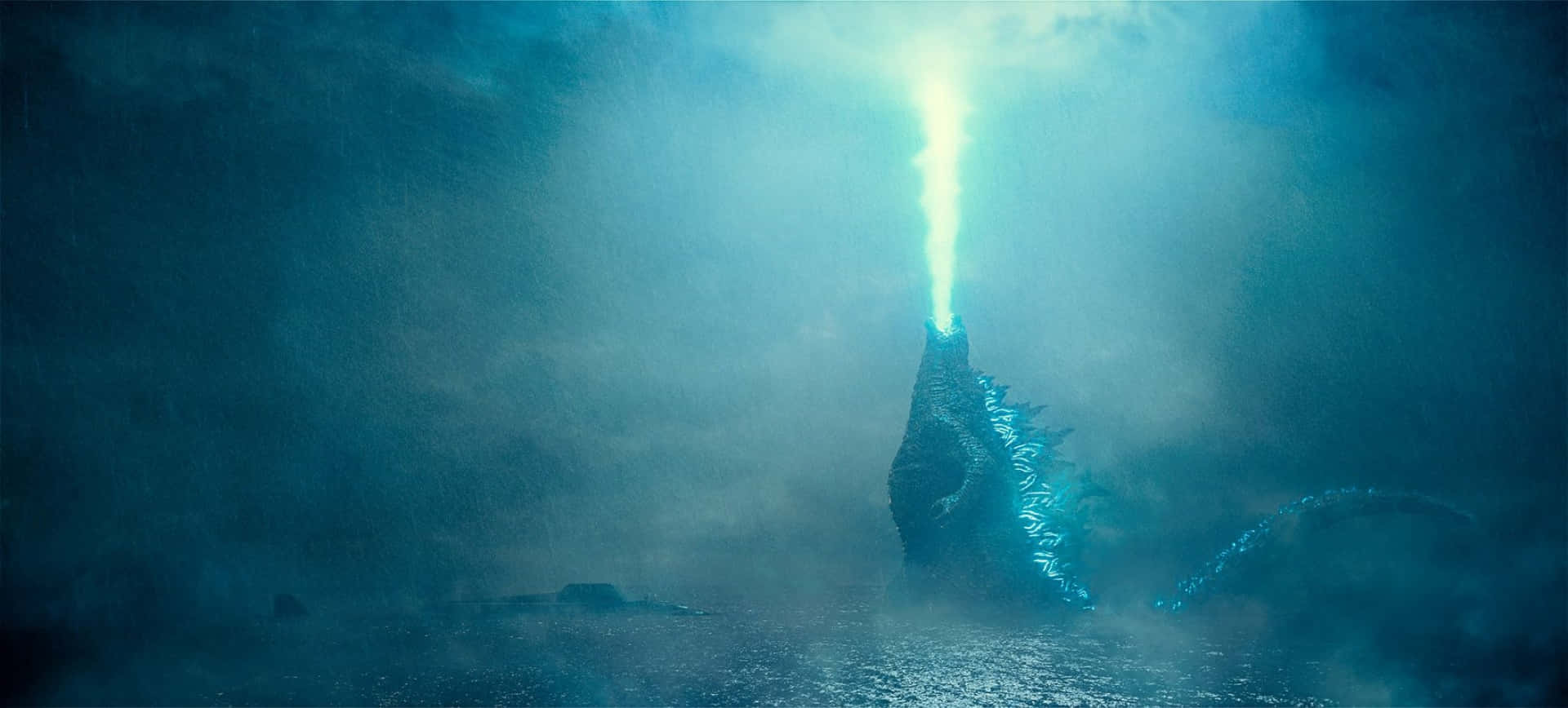 Godzilla unleashes his iconic Atomic Breath in an awe-inspiring display of power Wallpaper
