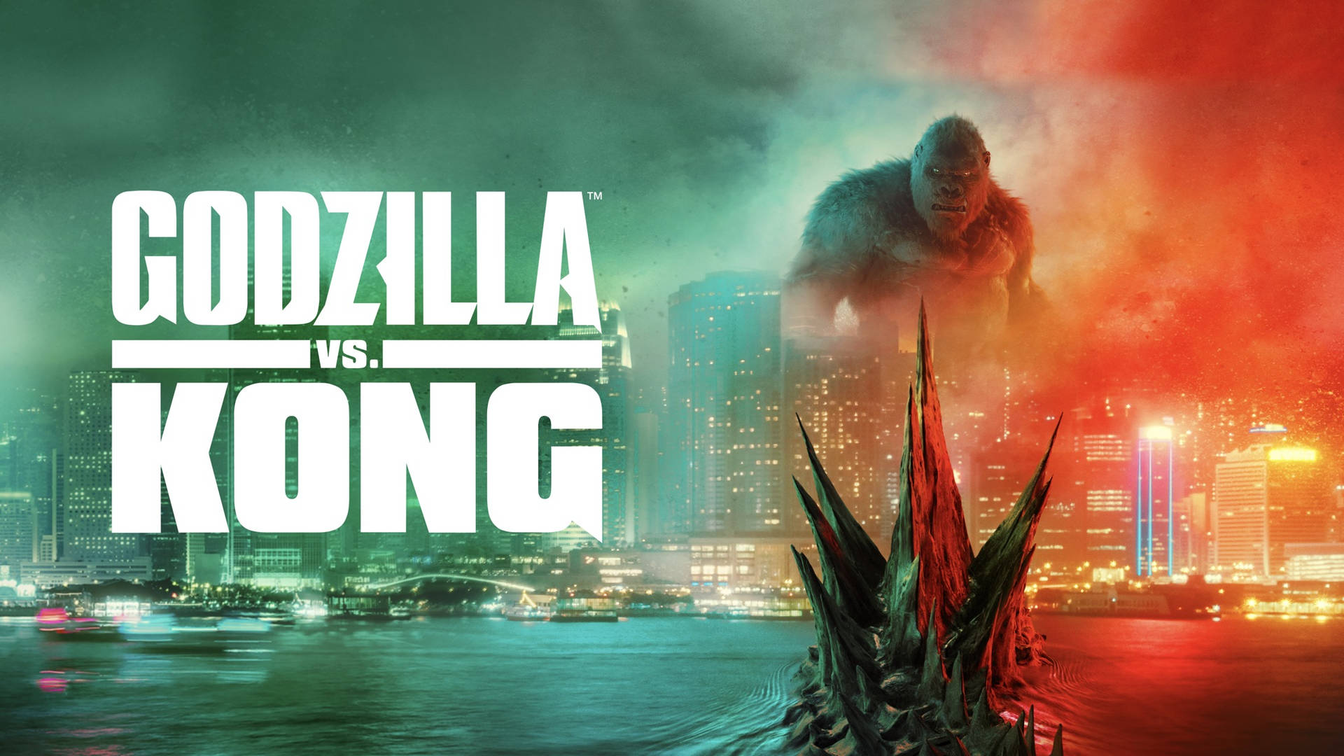 Godzilla vs Kong - et by med et stort statue af Godzilla og et mindre statue af Kong stående ansigt til ansigt Wallpaper