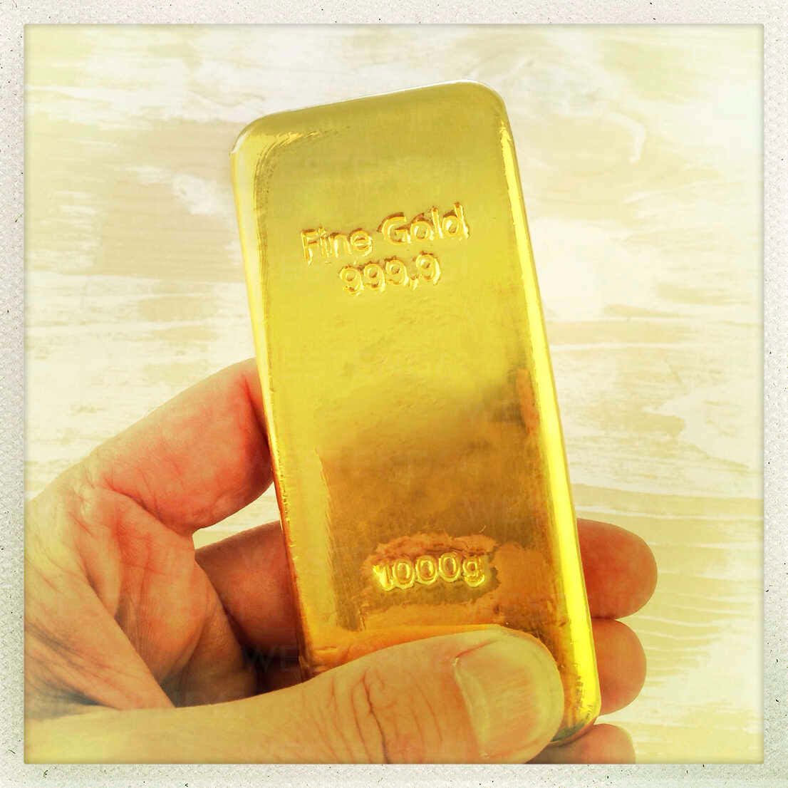 A Person Holding A Gold Bar