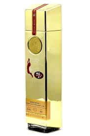 A Gold Bottle With A Red And Gold Label