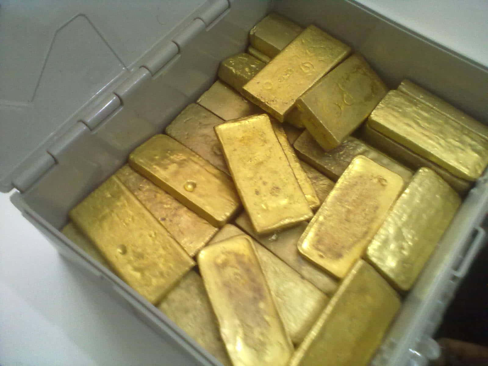 A Box Of Gold Bars Sitting On A Table