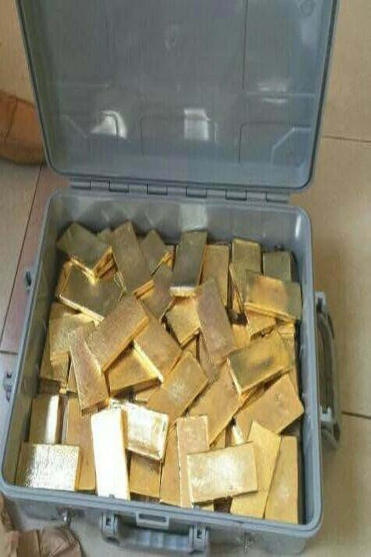 A Case Full Of Gold Bars In A Floor
