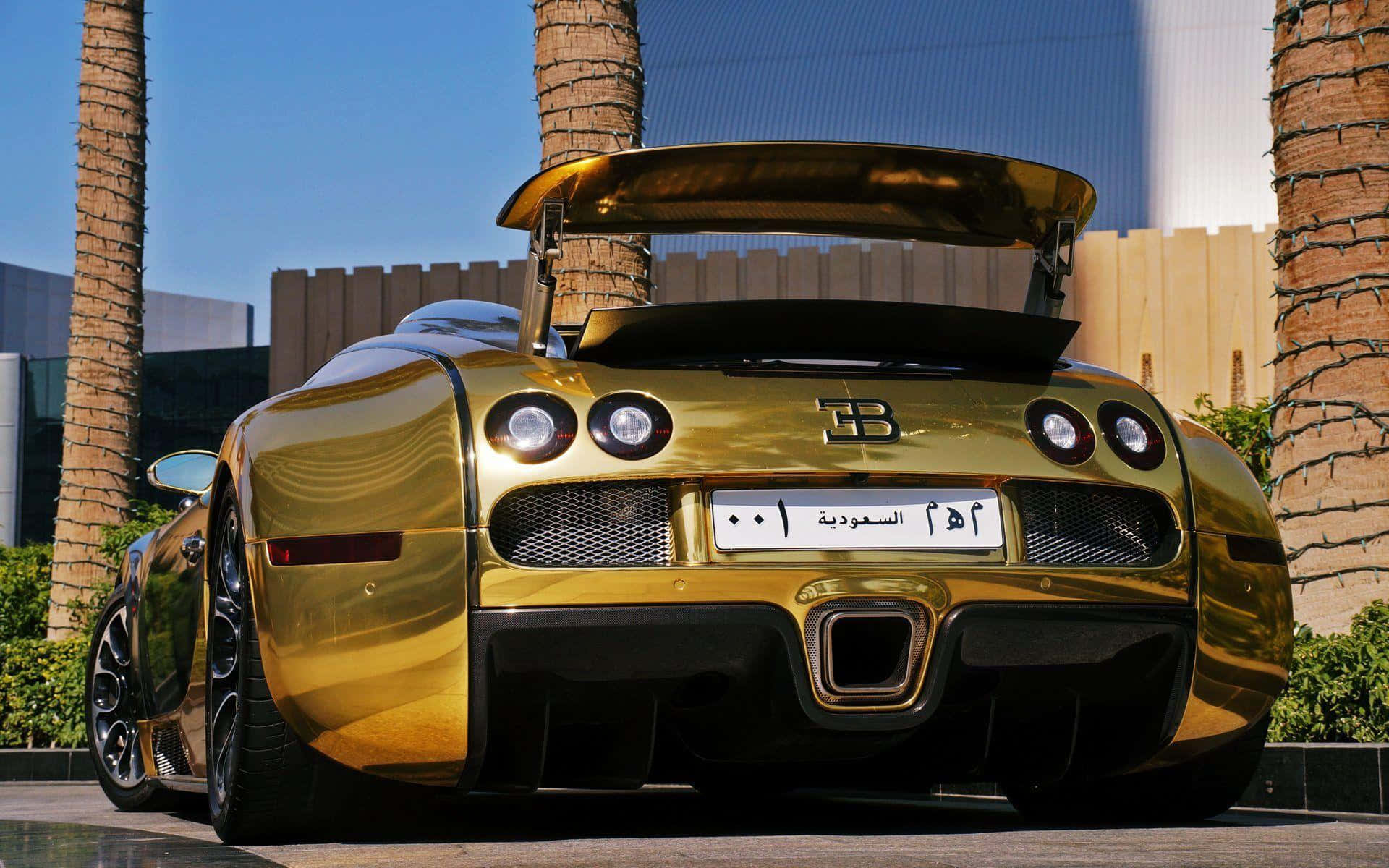 A Gold Bugatti Veyron Parked In Front Of Palm Trees Wallpaper