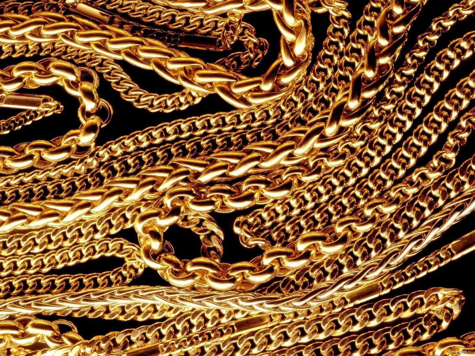A Bunch Of Gold Chains On A Black Background Wallpaper