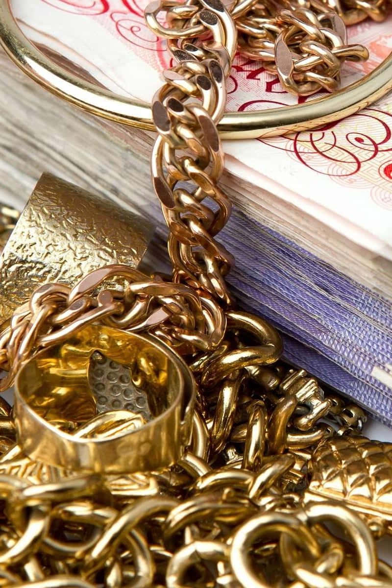 Gold Chains And Rings On A Pile Of Money Wallpaper