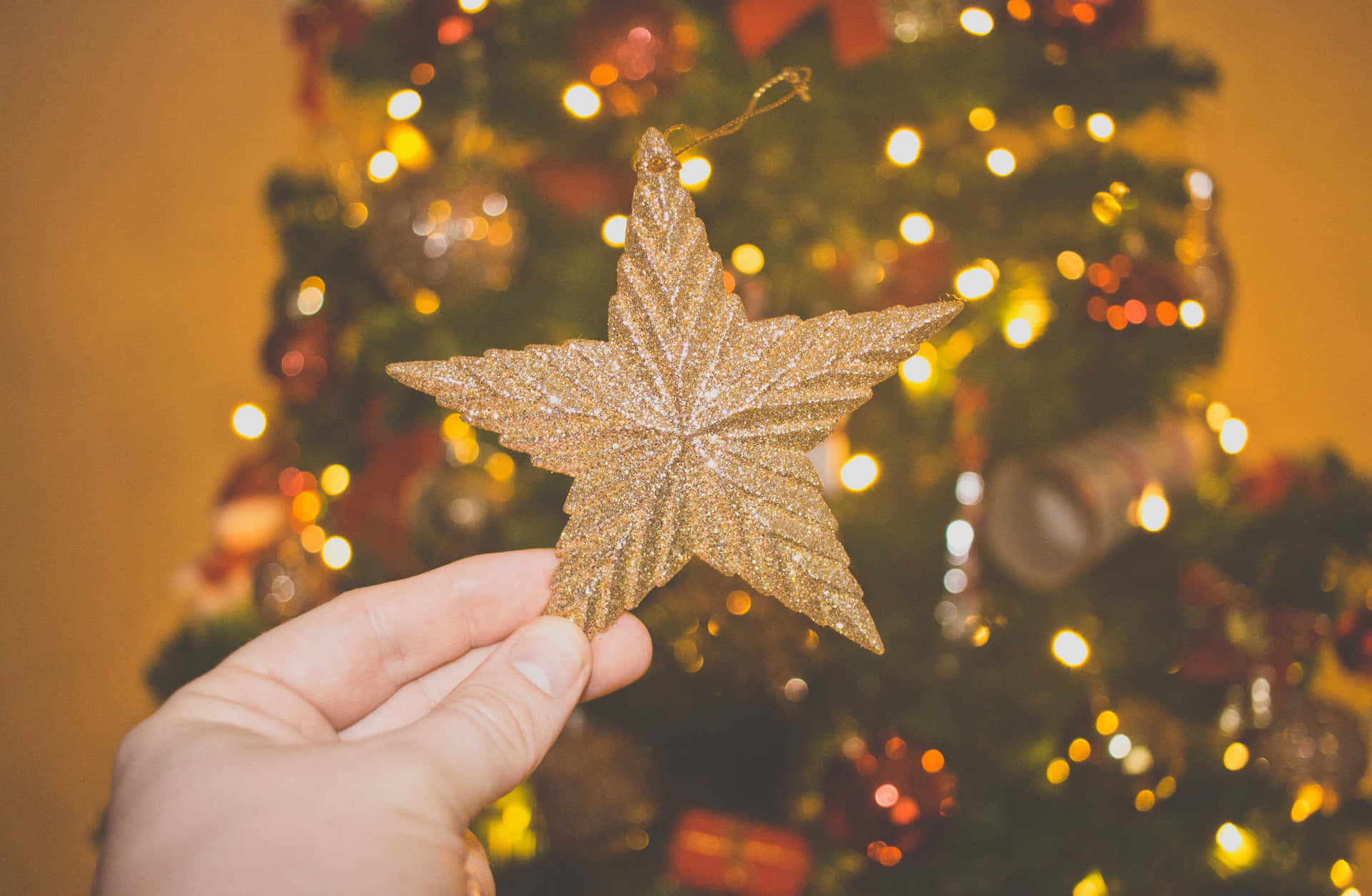 Celebrate a memorable Christmas with a festive golden decor Wallpaper