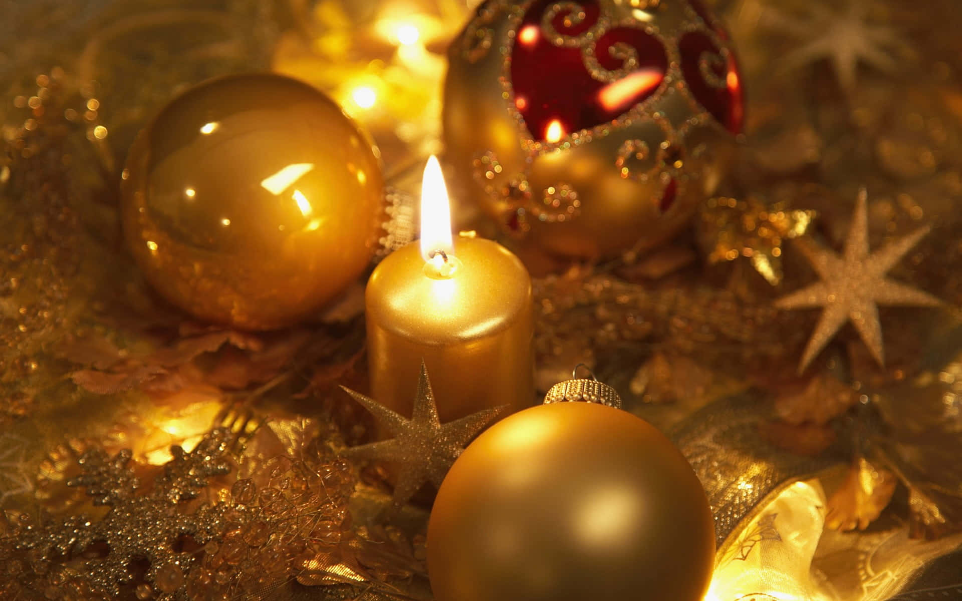 Download Christmas Candle And Ornaments On A Table | Wallpapers.com