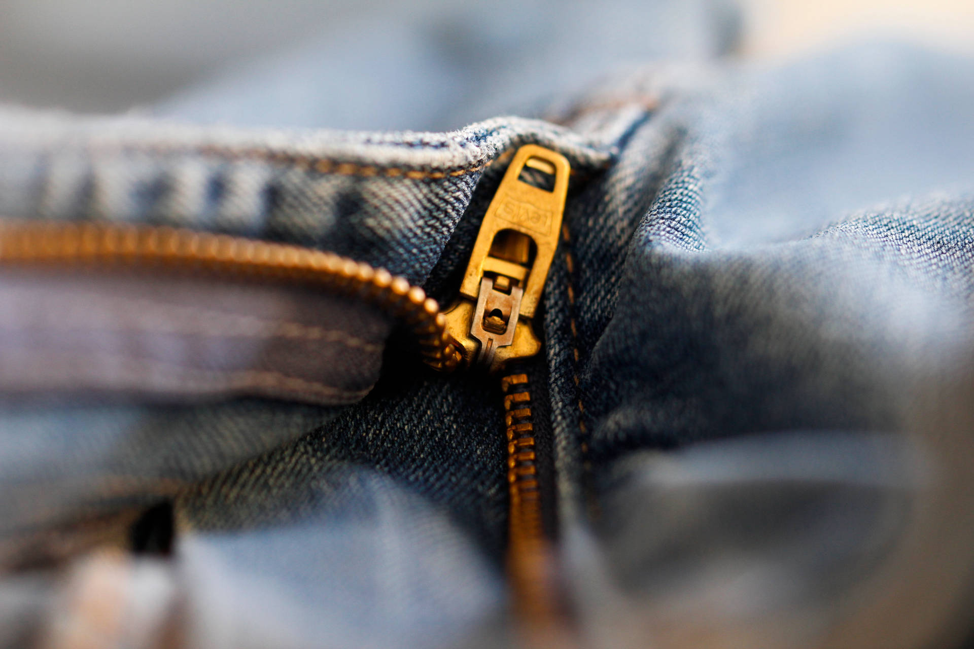Gold Color Zipper In Denim Jeans Background