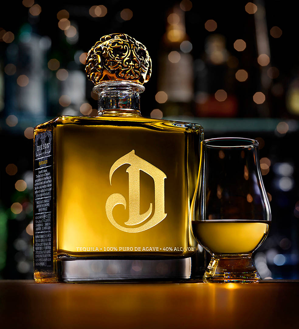 Gold Deleón Tequila Bottle And Glass Picture
