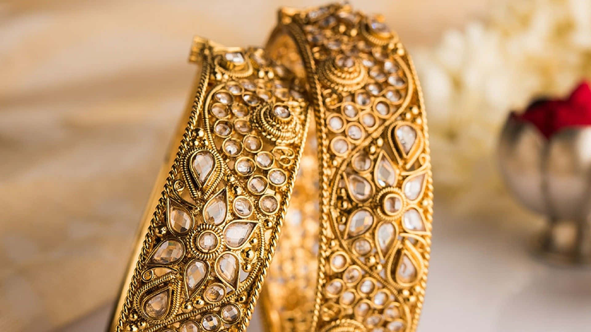 Gold Bangles With A Flower On Them