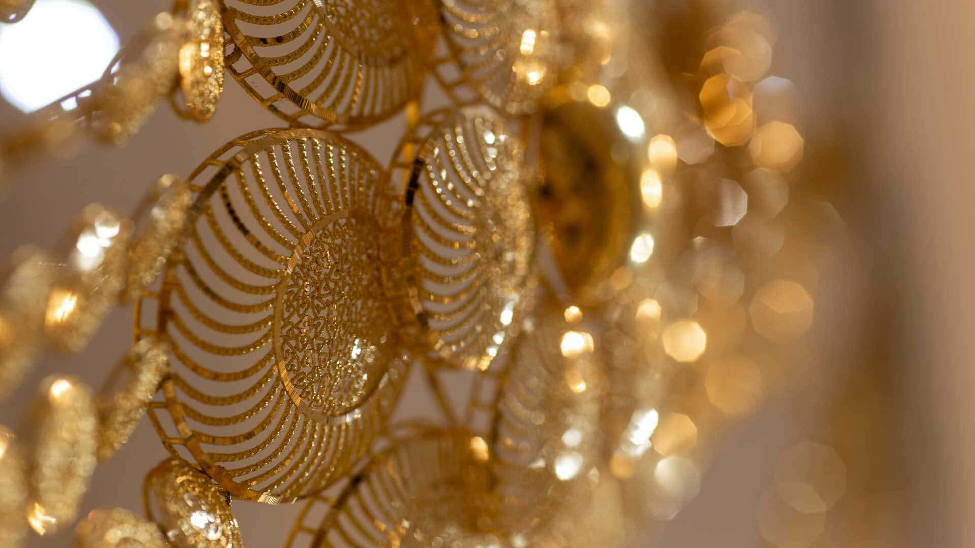 A Close Up Of A Gold Plated Chandelier