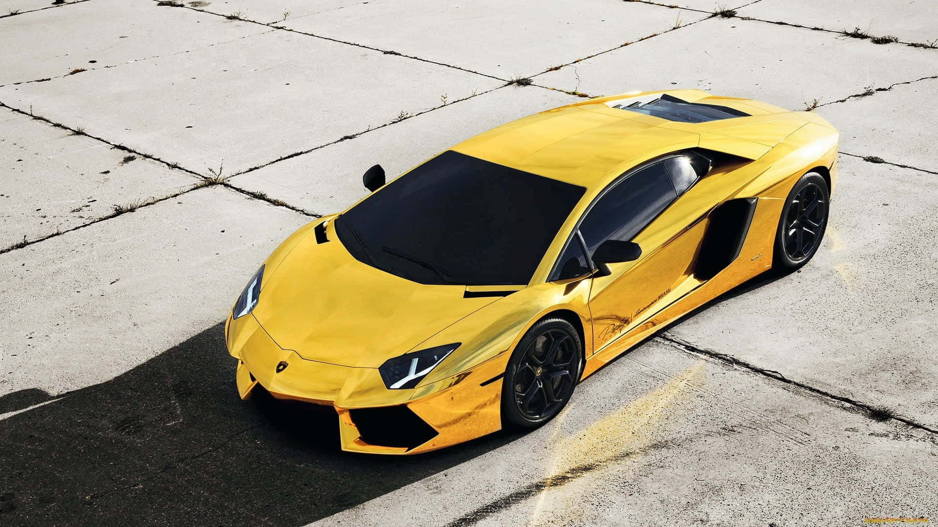 Yellow Gold Lamborghini On Display Wallpaper