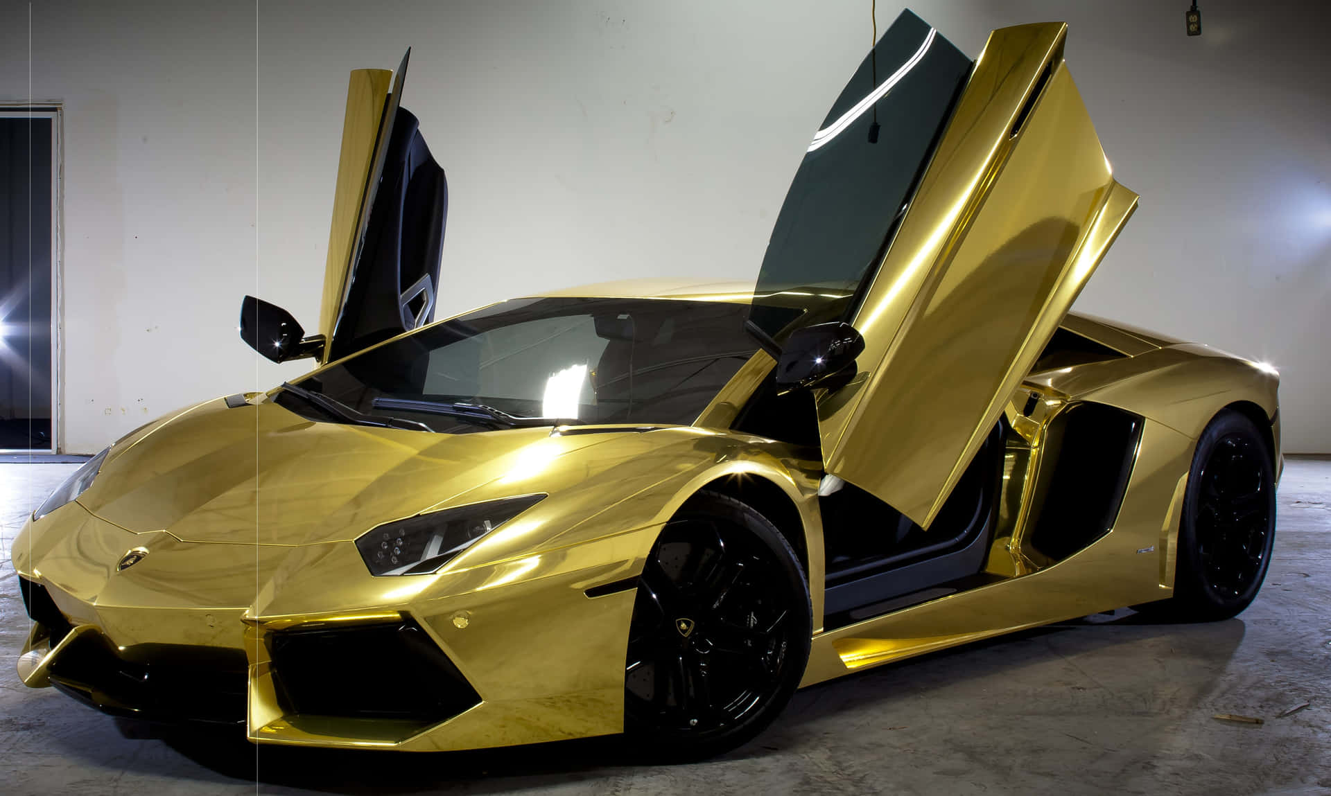 Plated Gold Lamborghini With Its Doors Open Wallpaper