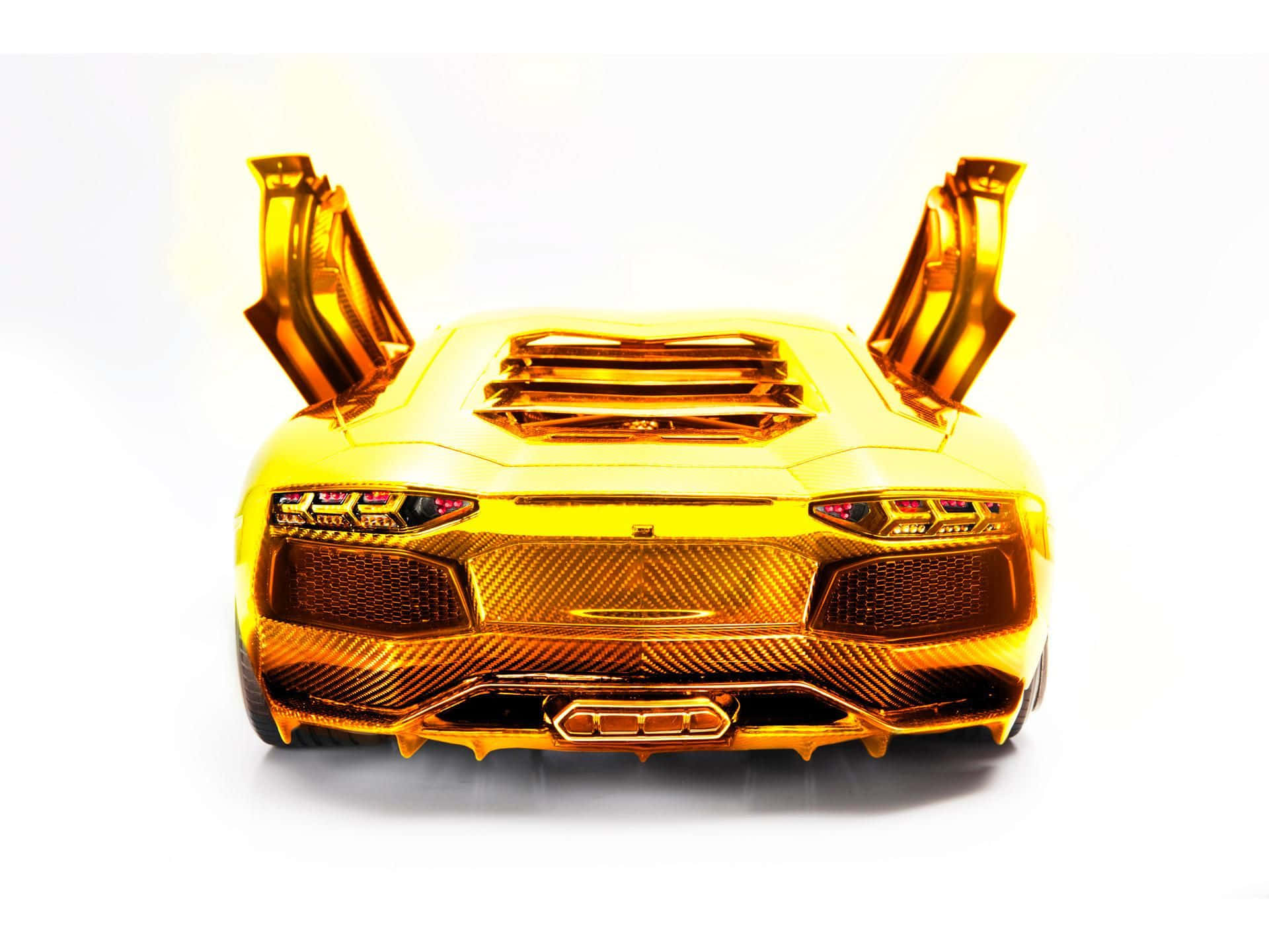 Enjoy the Luxury and Power of a Gold Lamborghini Wallpaper
