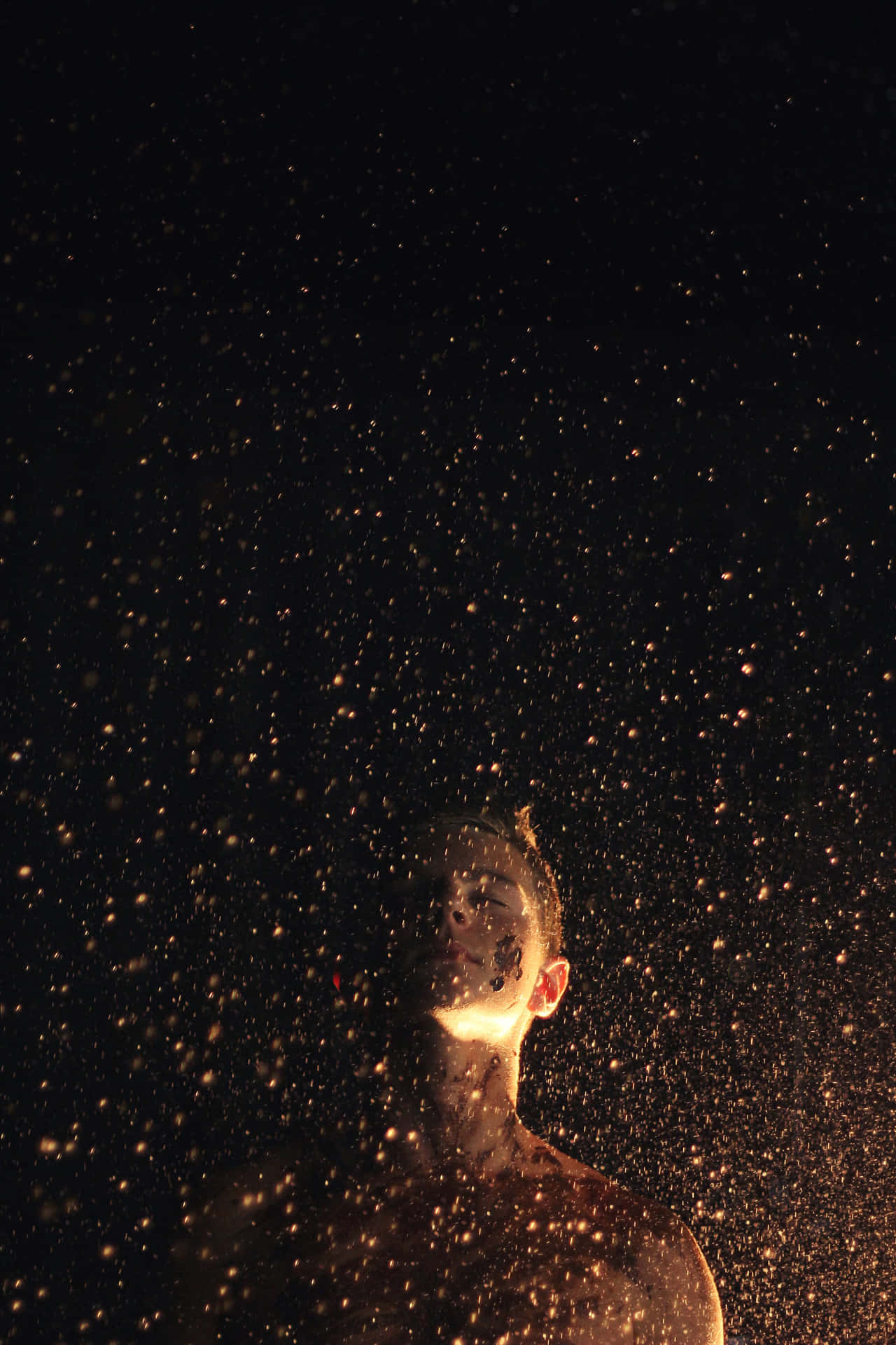 Gold Sparkle Surrounding A Man Background