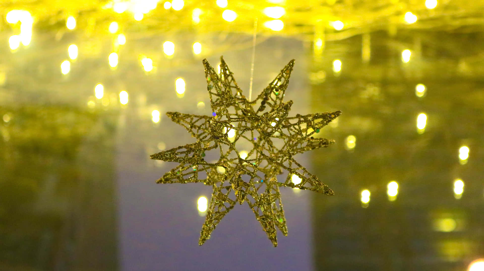 A Star Decoration Hanging From A Light Fixture