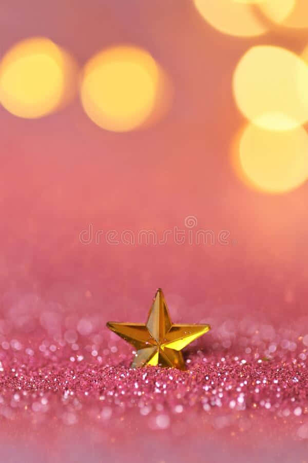 Eingoldener Stern Auf Einem Rosa Hintergrund Mit Bokeh-lichter-aufnahmen. Wallpaper