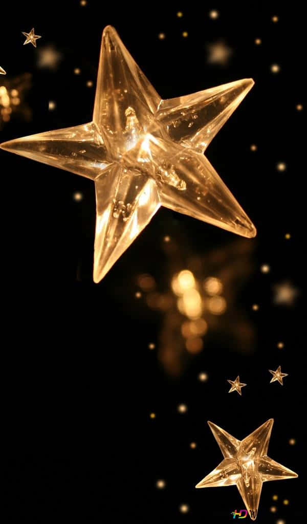A Group Of Gold Stars Floating In The Air Wallpaper